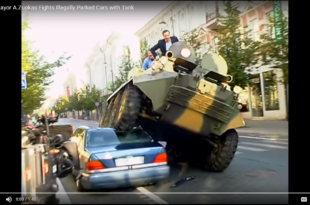 a man riding a tank on top of a car