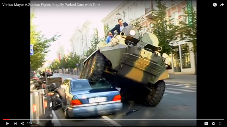 a man riding a tank on top of a car