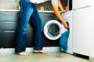 a person putting clothes into a washing machine