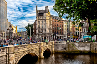 a bridge over a river with people walking on it