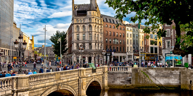 a bridge over a river with people walking on it