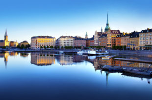 a city with many buildings and boats on the water