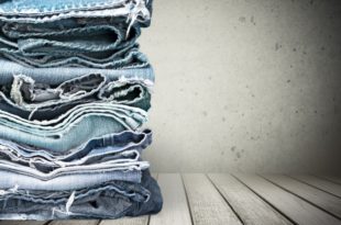 a stack of jeans on a table