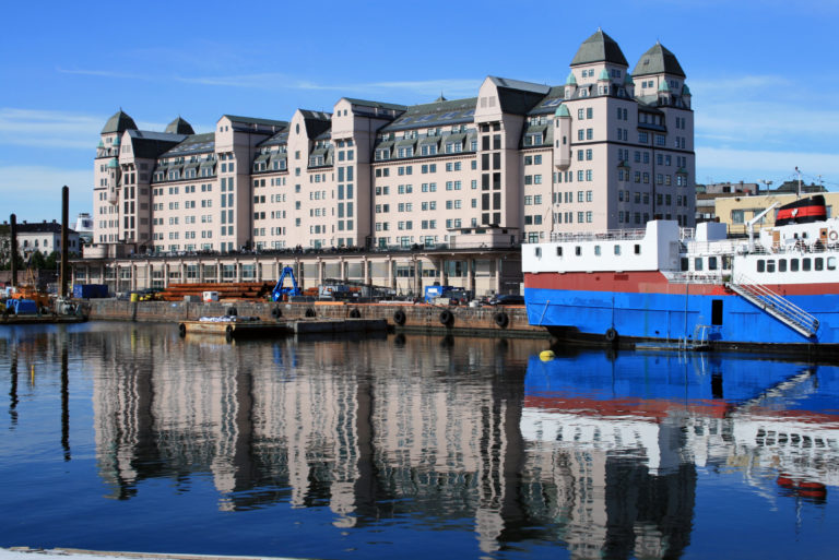 a large building with a boat in the water