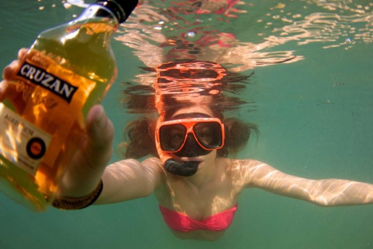 a woman in a garment and goggles underwater