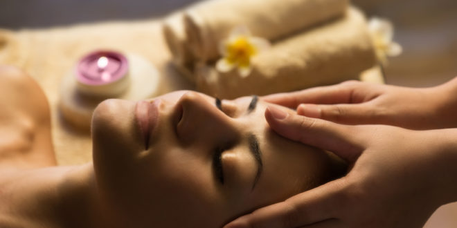 a woman receiving a face massage