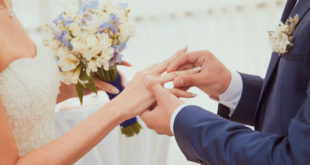 a man putting a ring on a woman's hand