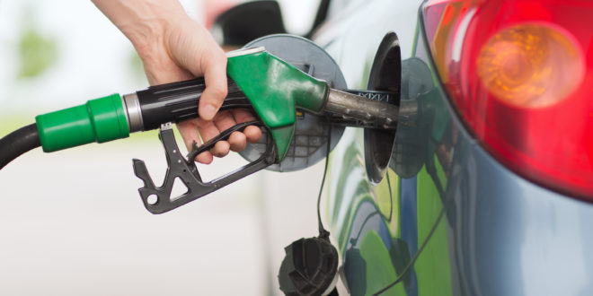 a hand holding a gas pump