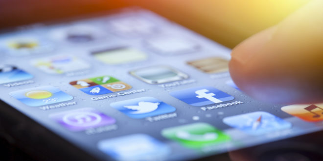 a finger touching a cell phone