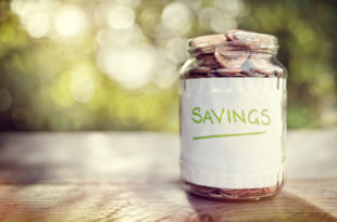 a jar of coins with a white label