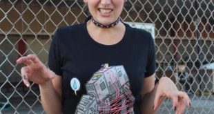 a woman wearing pink ears and a t-shirt