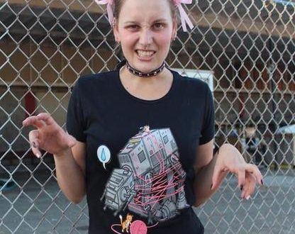 a woman wearing pink ears and a t-shirt