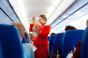 a woman in a red uniform holding a bag