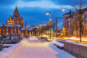 a snow covered sidewalk and street lights