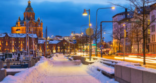 a snow covered sidewalk and street lights