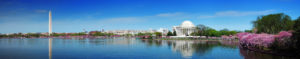 a large white building next to a body of water