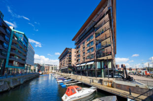 a water way with boats and buildings on the side