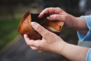a person holding an empty wallet