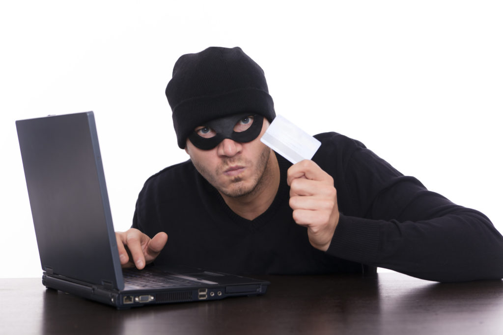 This is what hackers look like, according to stock image websites. They wear a mask, just in case you can see them through the laptop.
