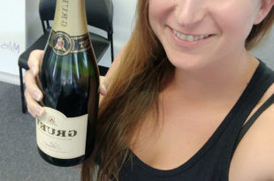 a woman holding a bottle of champagne