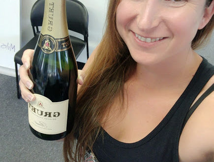 a woman holding a bottle of champagne