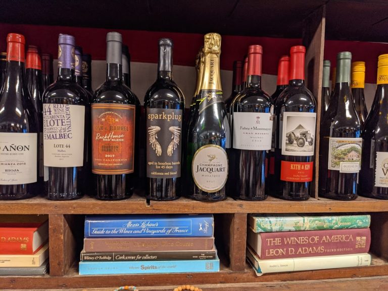 a shelf with bottles of wine
